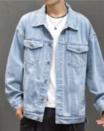 Blouson en jean homme, en coton, bleu clair, avec boutonnage simple, et 2 poches au niveau de la poitrine, porté par un homme