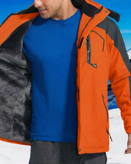 Un homme portant un blouson ski rouge avec arrière plan montagne et neige